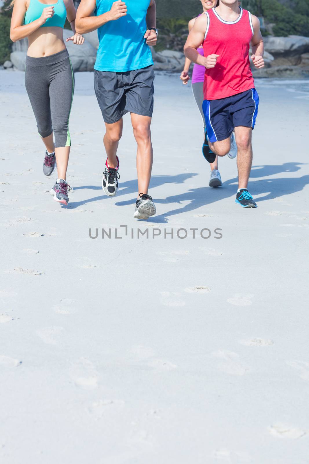 Friends doing jogging together at the beach