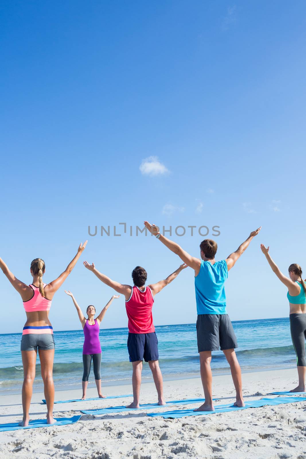 Friends stretching together with their teacher by Wavebreakmedia