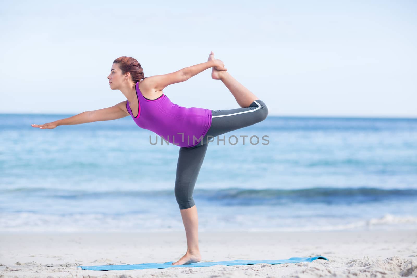 Brunette doing yoga on exercise mat by Wavebreakmedia