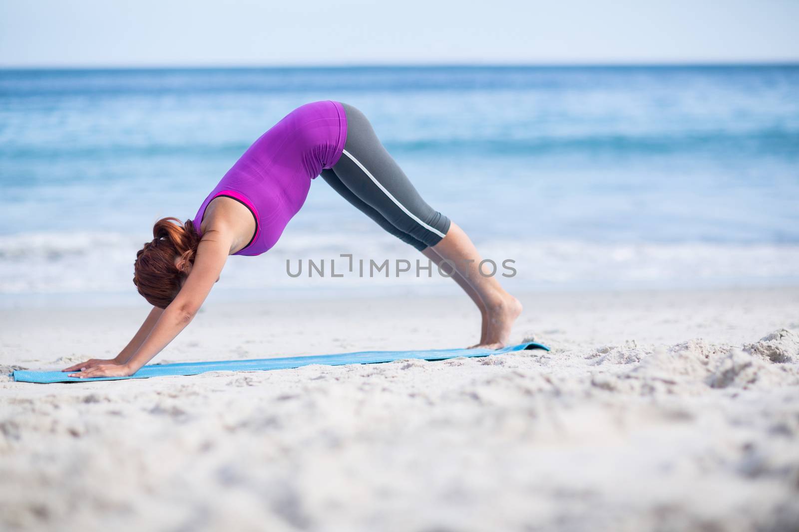 Brunette doing yoga on exercise mat by Wavebreakmedia