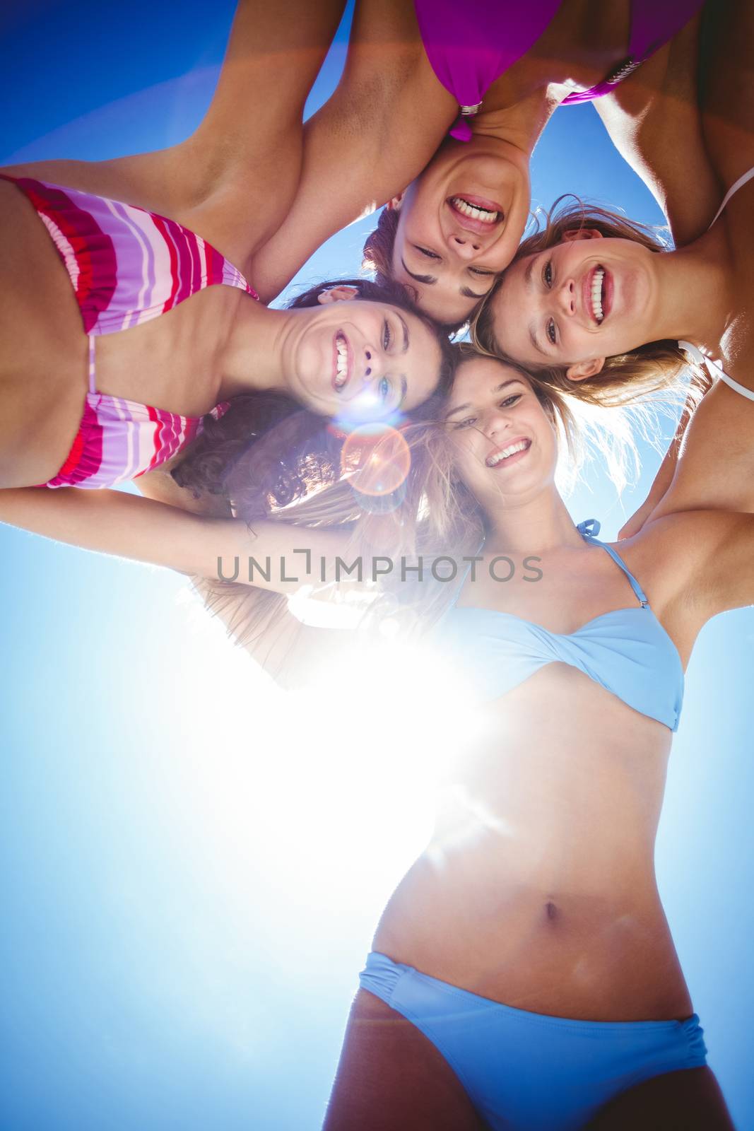 Beautiful women standing in circle at the beach