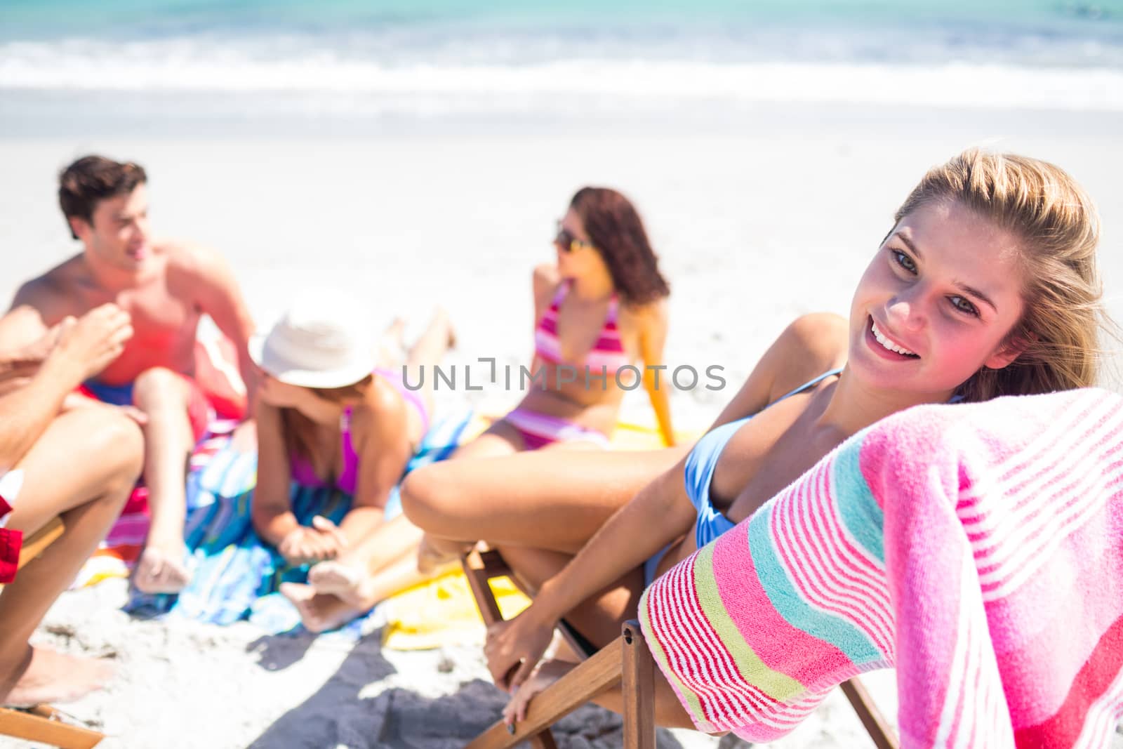 Happy friends sunbathing together at the beach