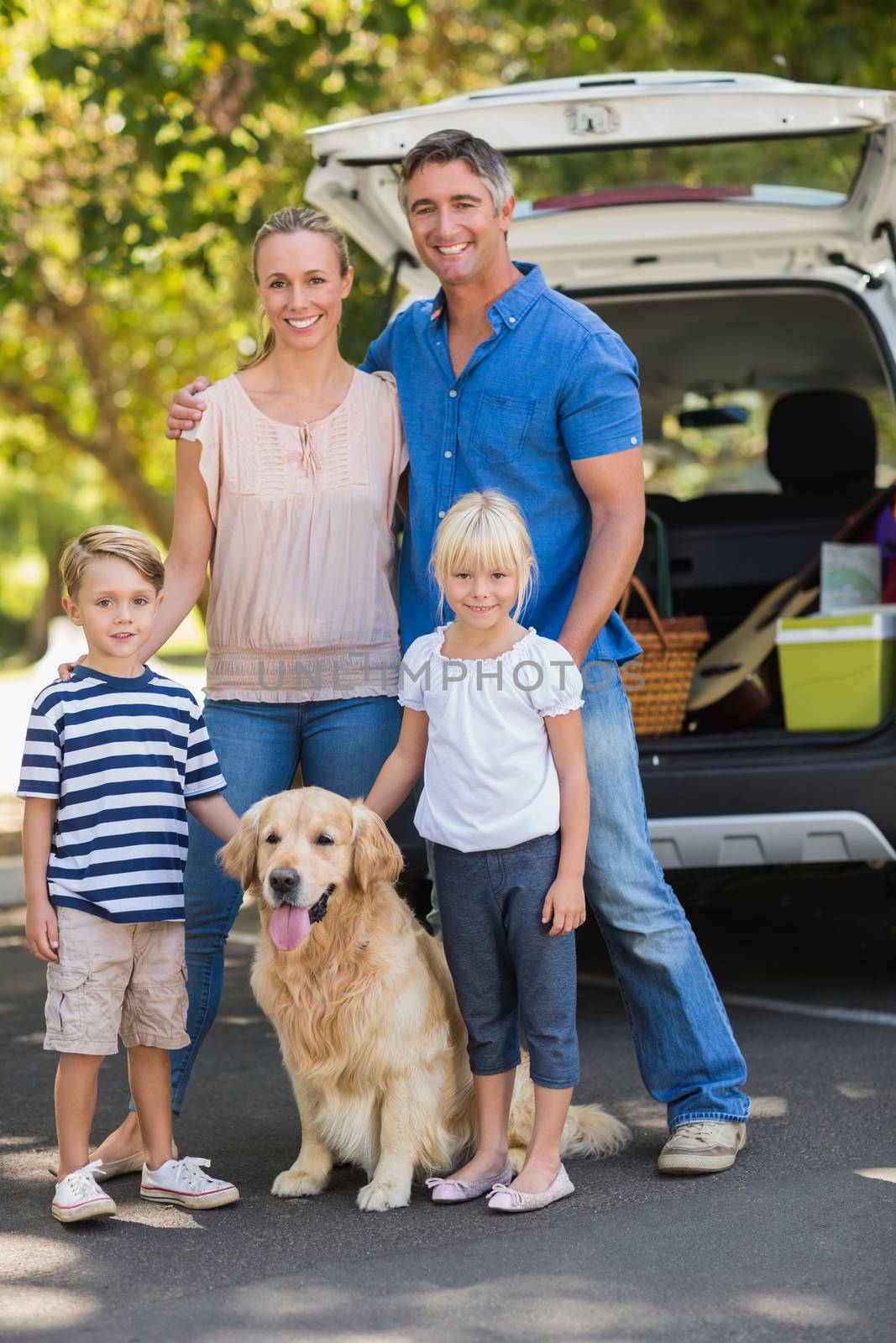 Happy family with their dog in the park on a sunny day