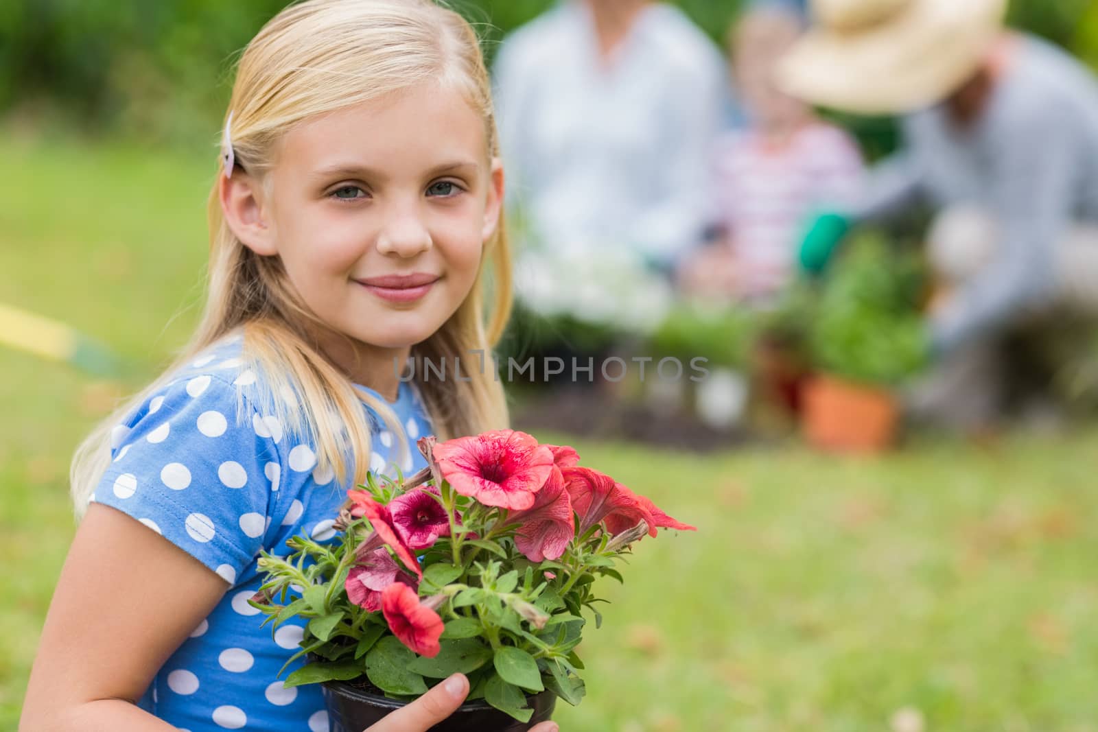 Young girl sitting with flower pot  by Wavebreakmedia