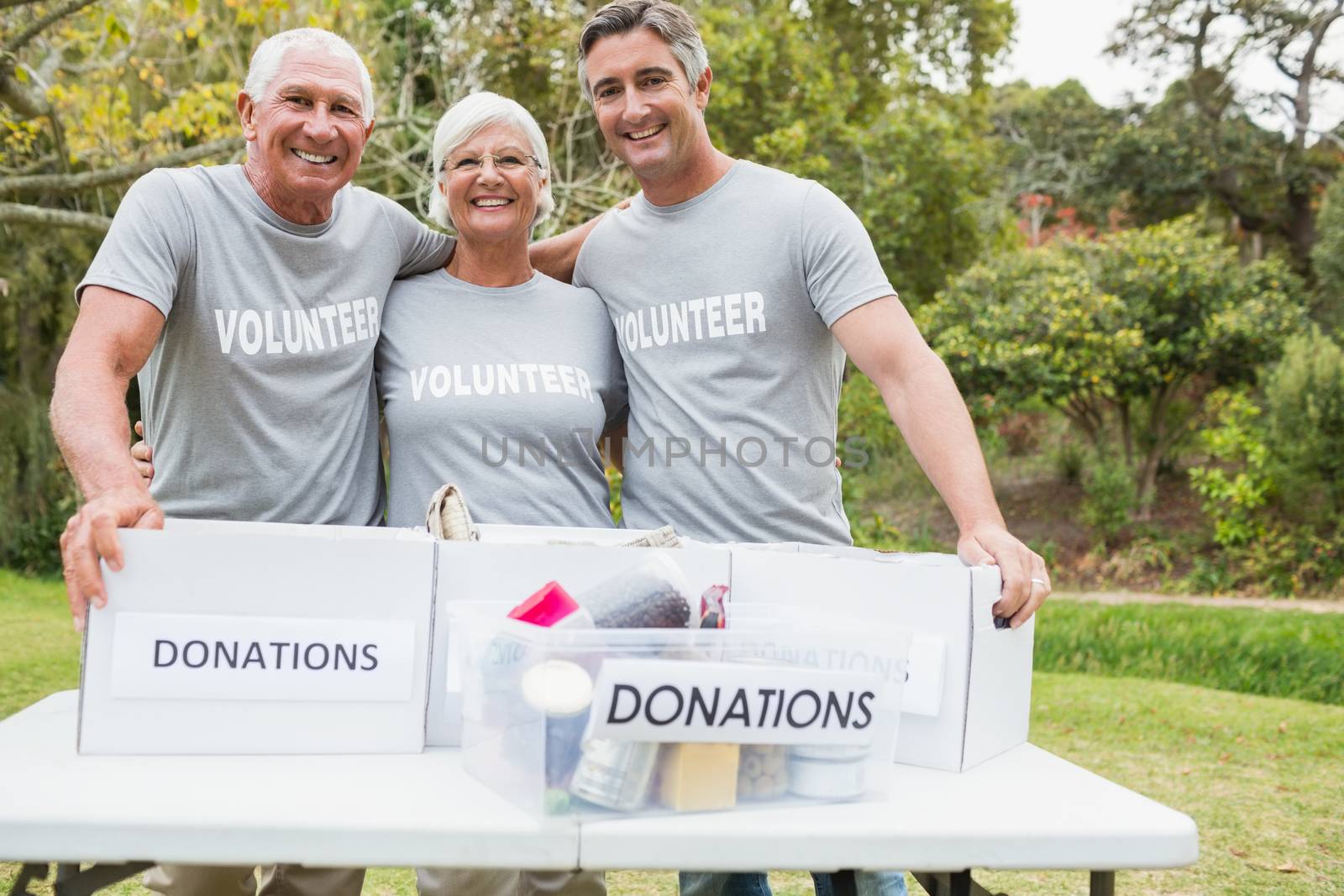 Happy family volunteer smiling at camera on a sunny day 