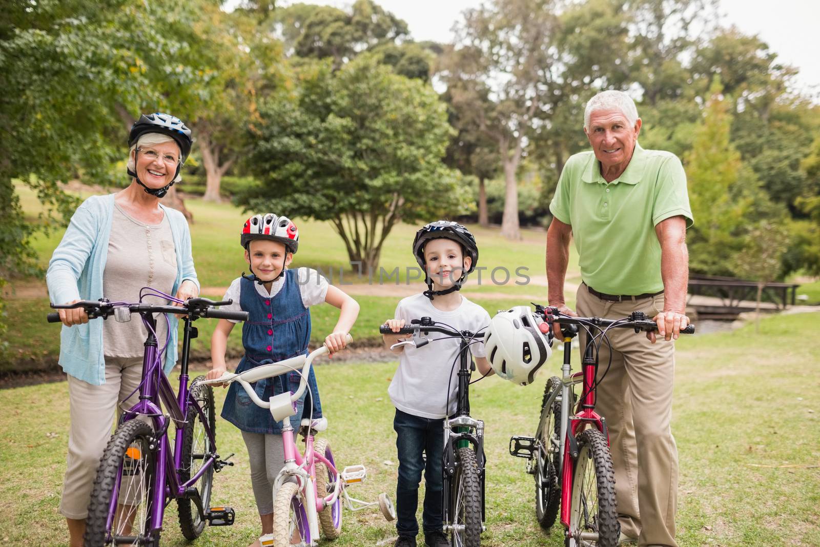 Happy grandparents with their grandchildren on their bike by Wavebreakmedia