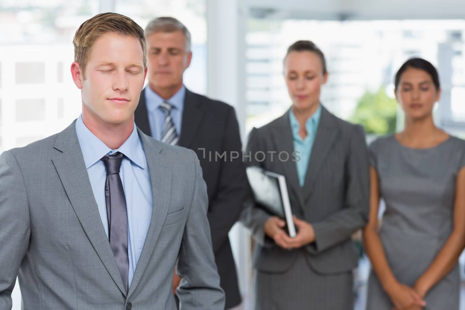 Business team meditating eyes closed by Wavebreakmedia