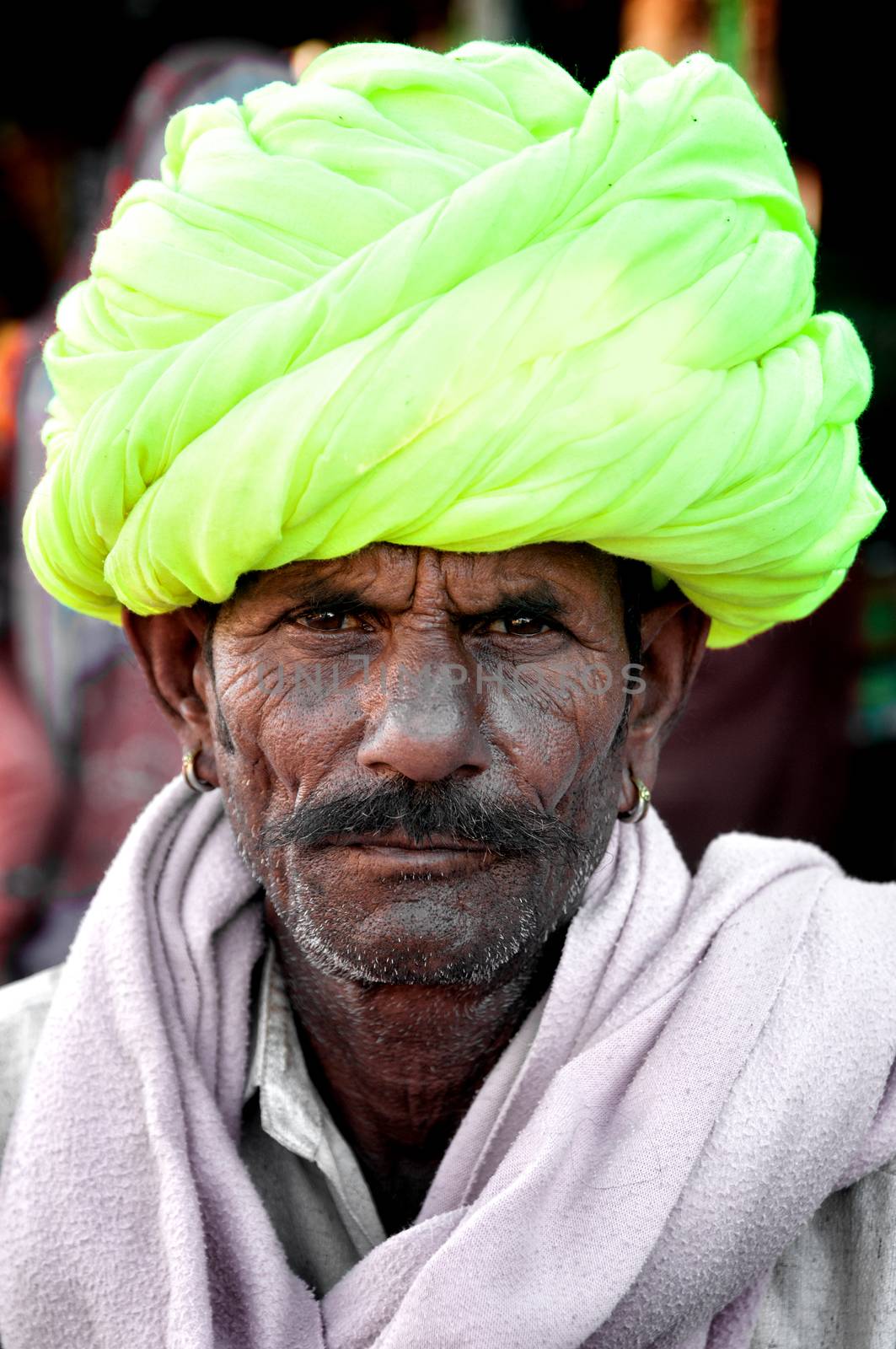 Indian man with mustache and colourful turban portrait Pushkar, India. March 3, 2013