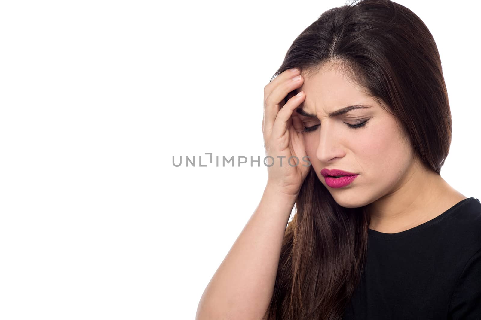 Worried young woman touching her forehead