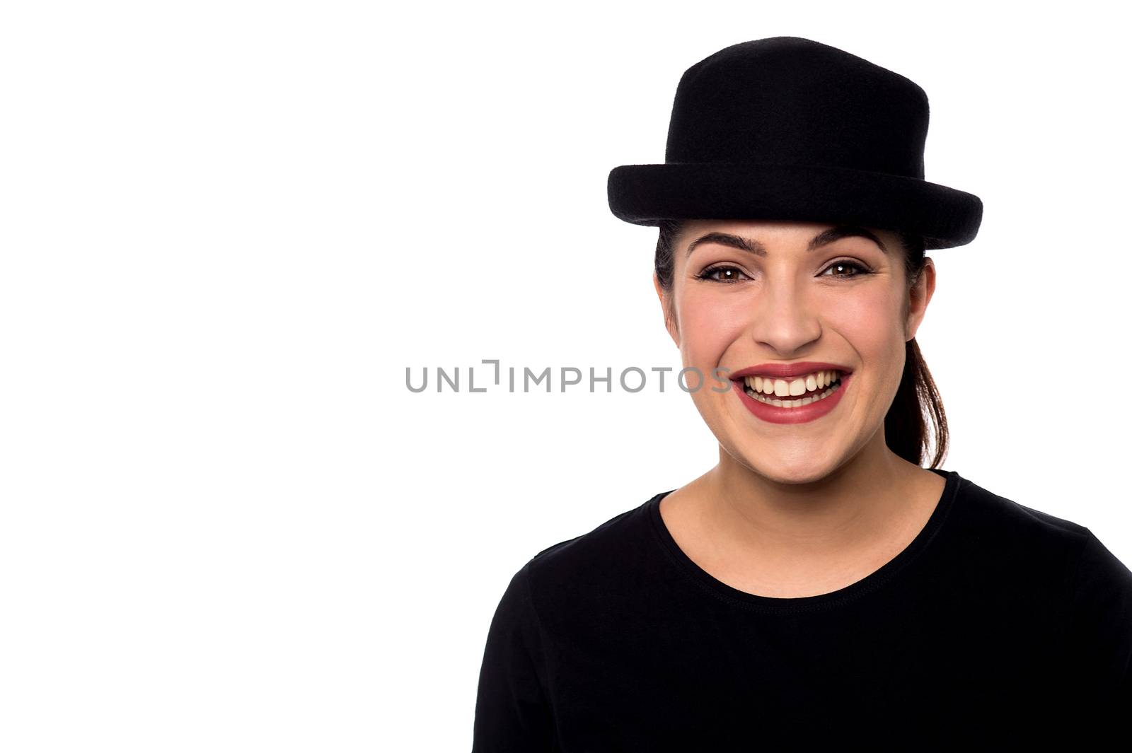 Cheerful woman with black hat over white