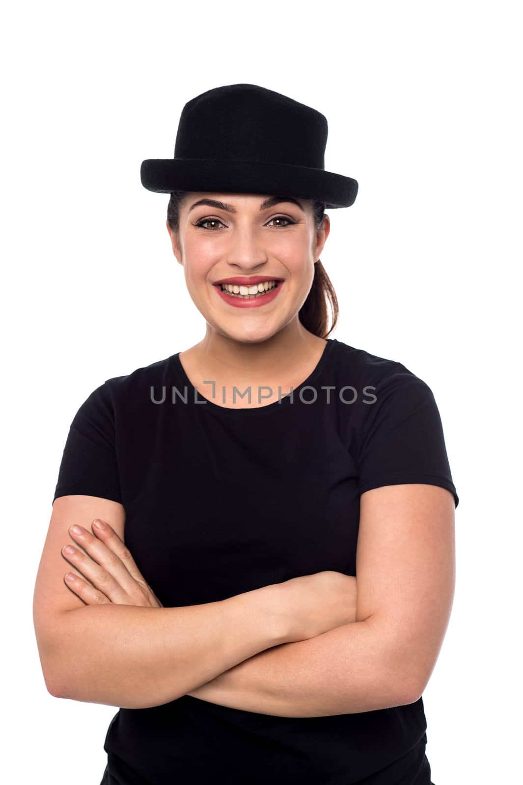Smiling young woman with hat and folded arms