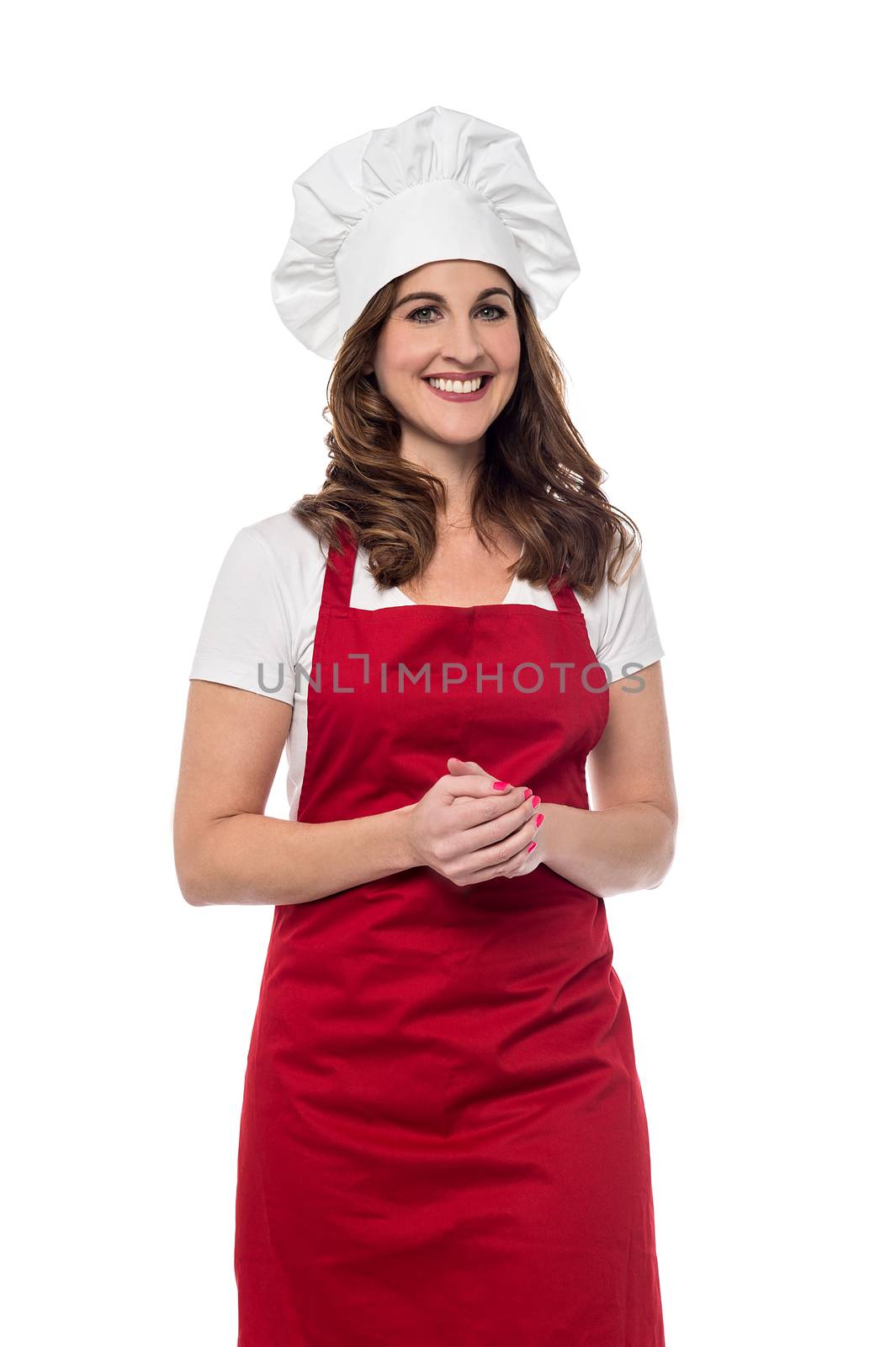 Female chef posing with hands clasped