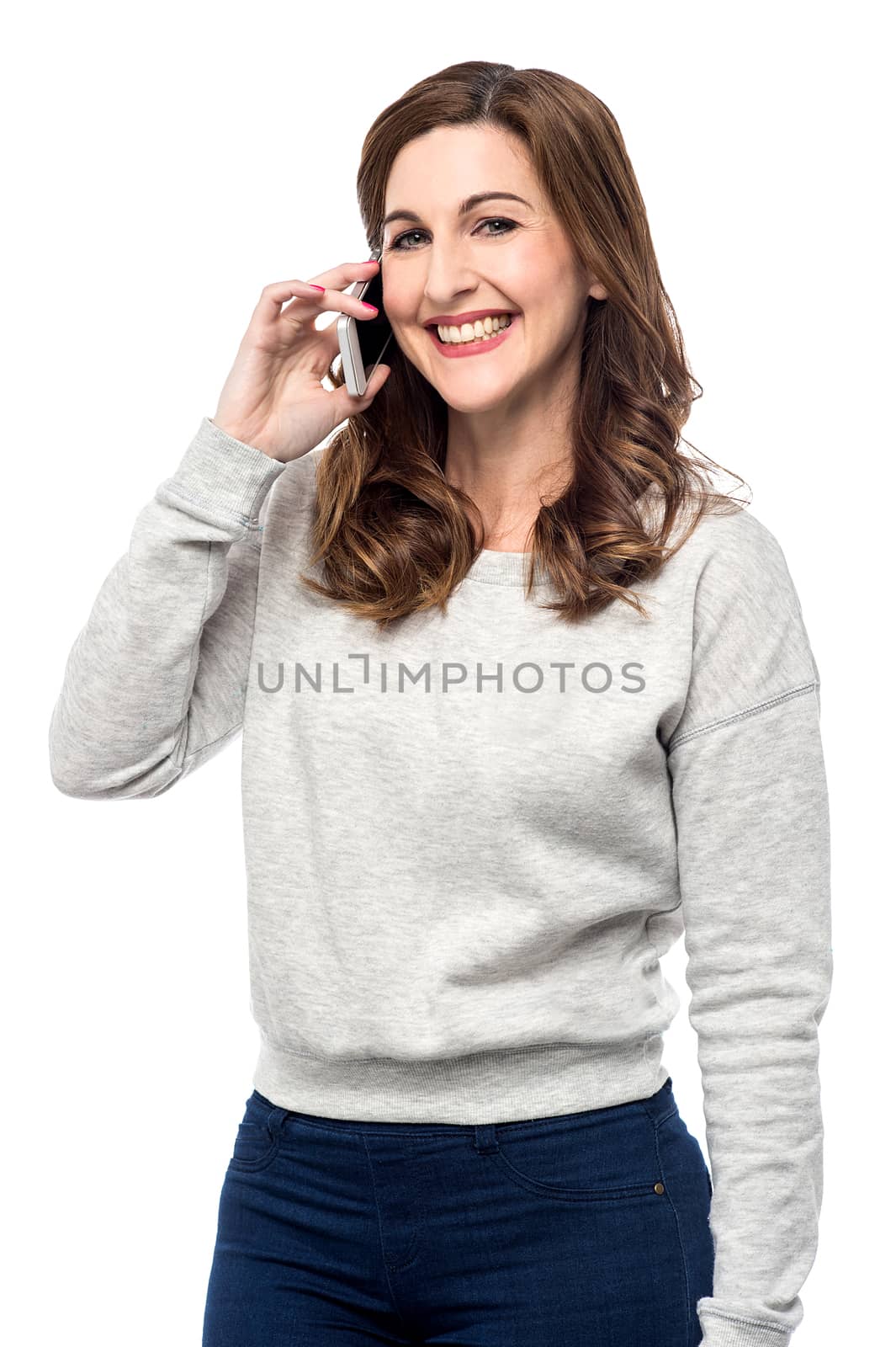 Pretty woman talking on cell phone over white
