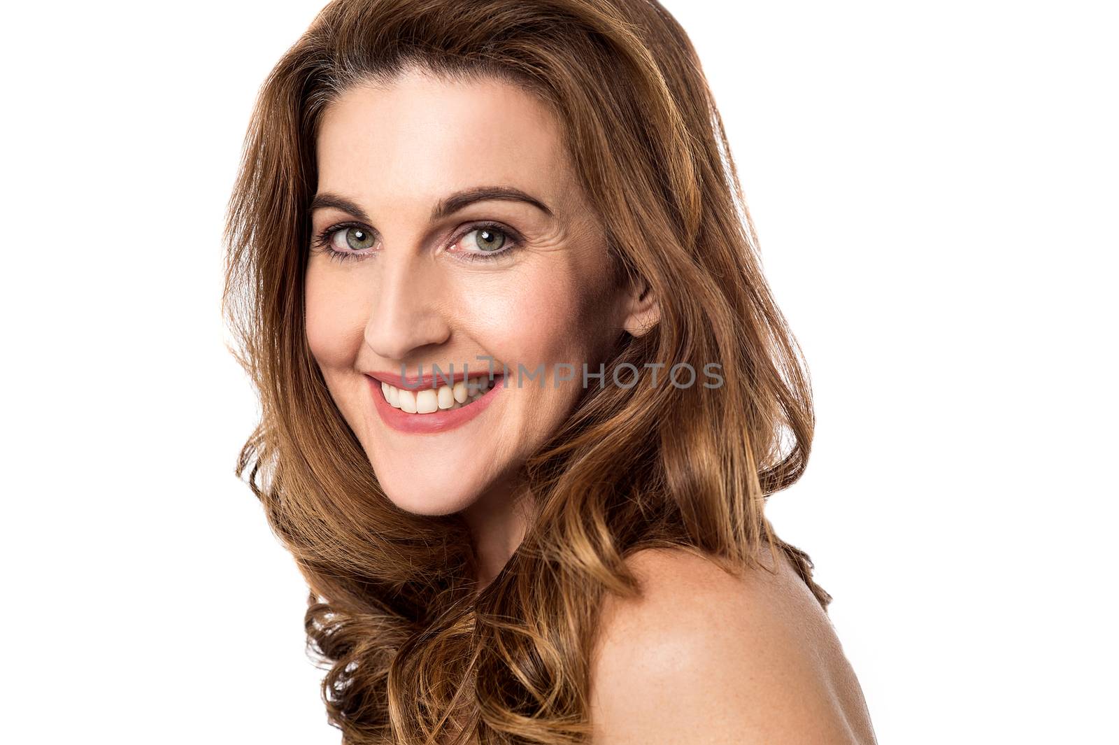 Smiling woman looking into camera by stockyimages