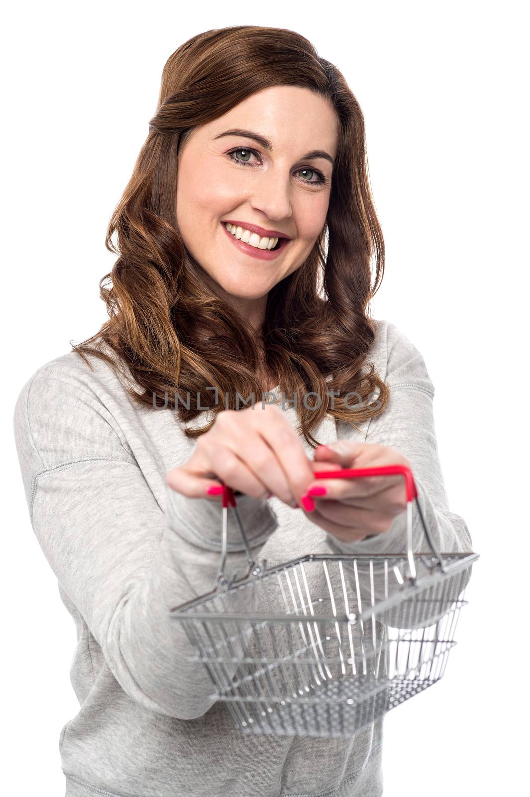 Smiling woman showing mini shopping basket