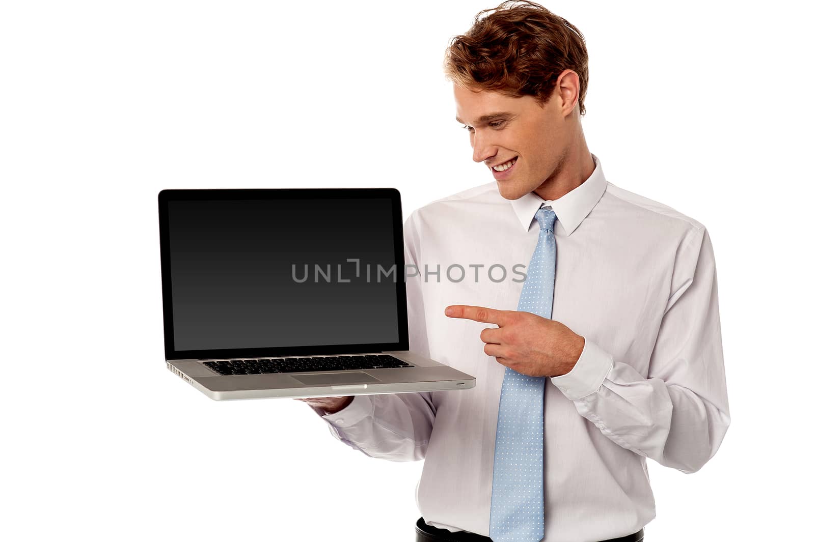 Happy salesman pointing a brand new laptop