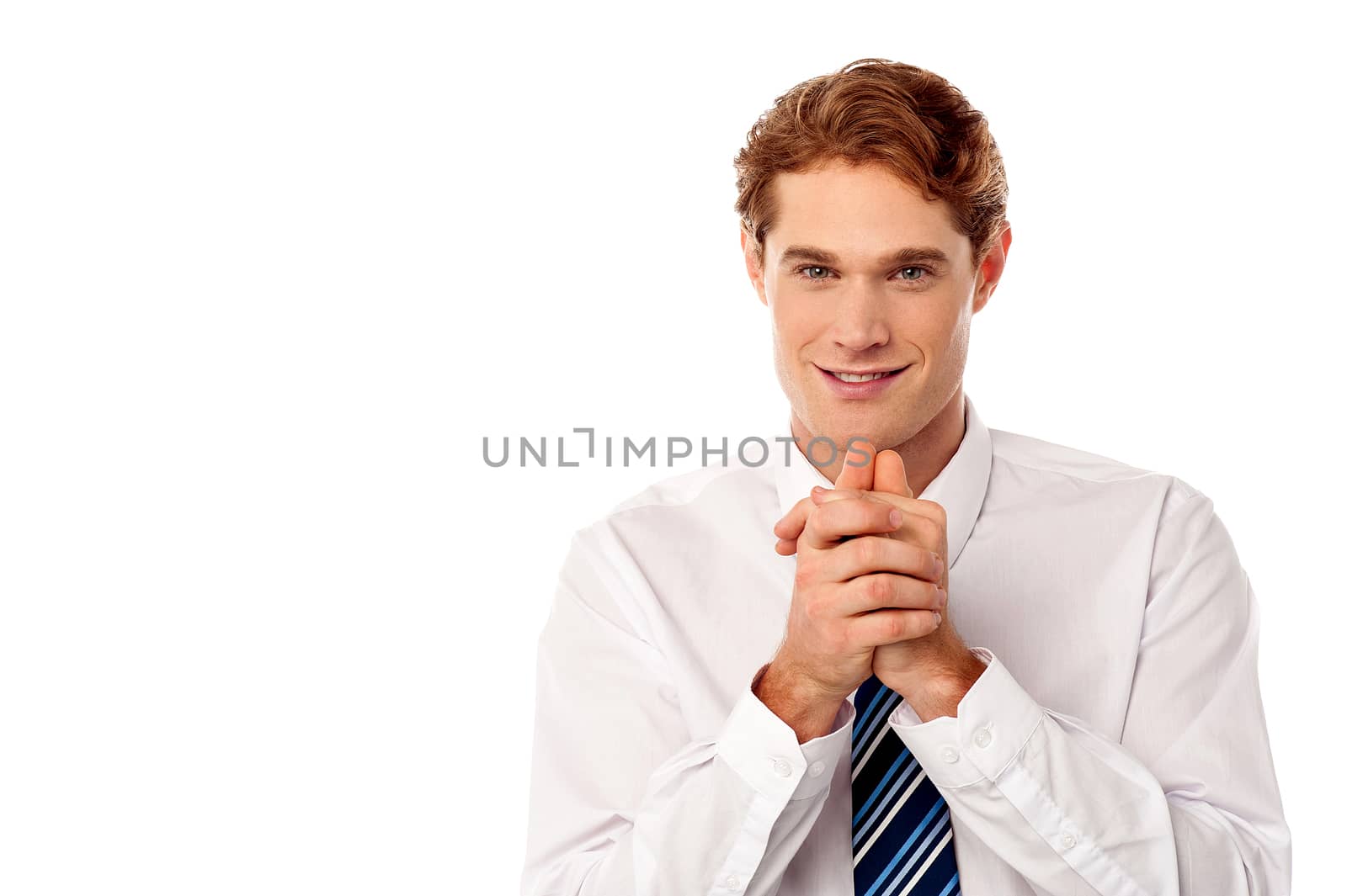 Smart young male executive with hands clasped
