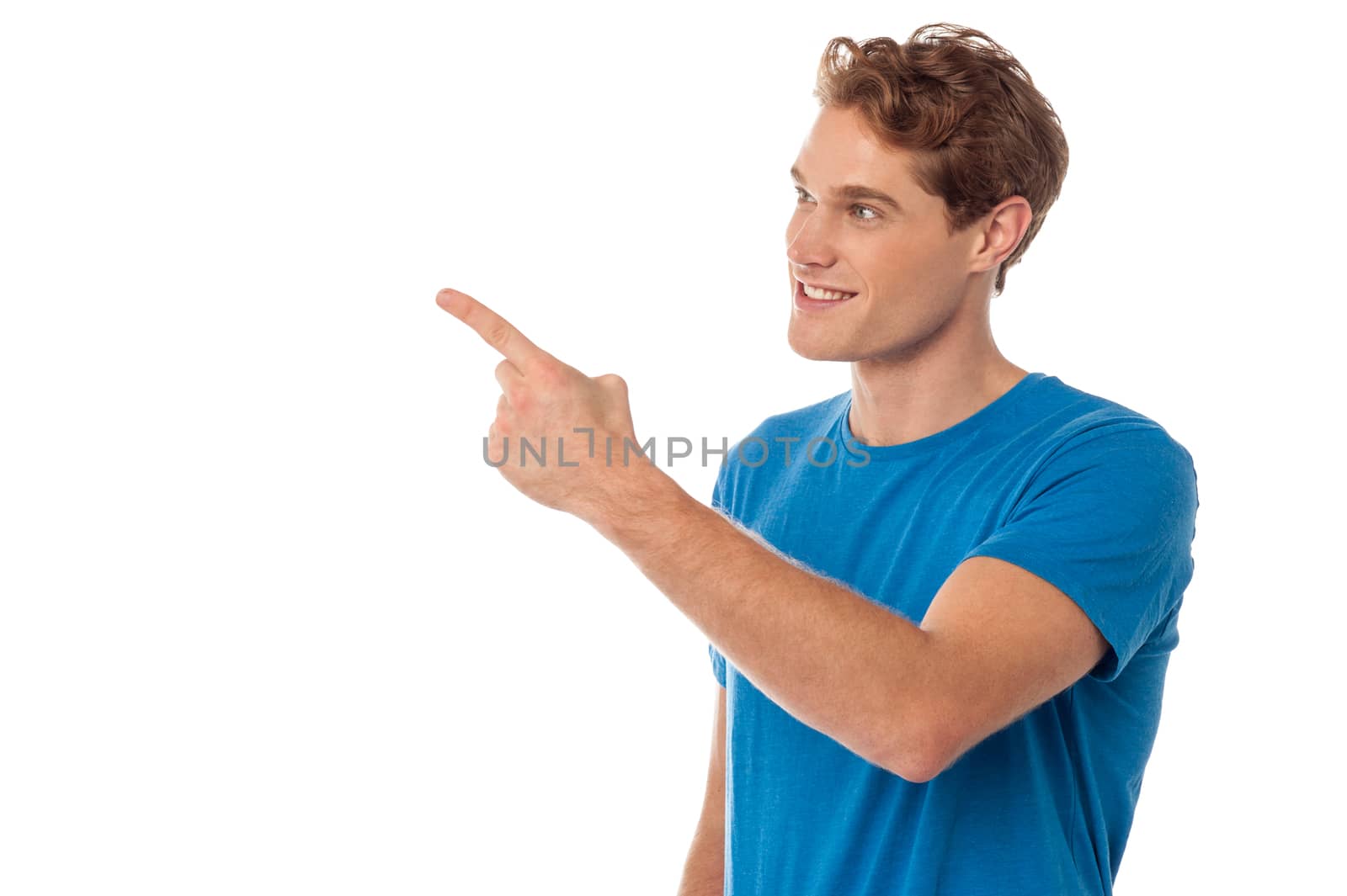 Casualy dressed man pointing at copy space