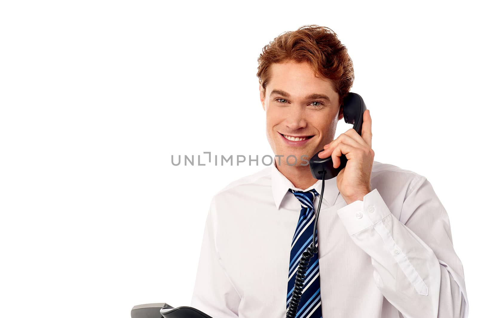 Handsome male executive attending a phone call
