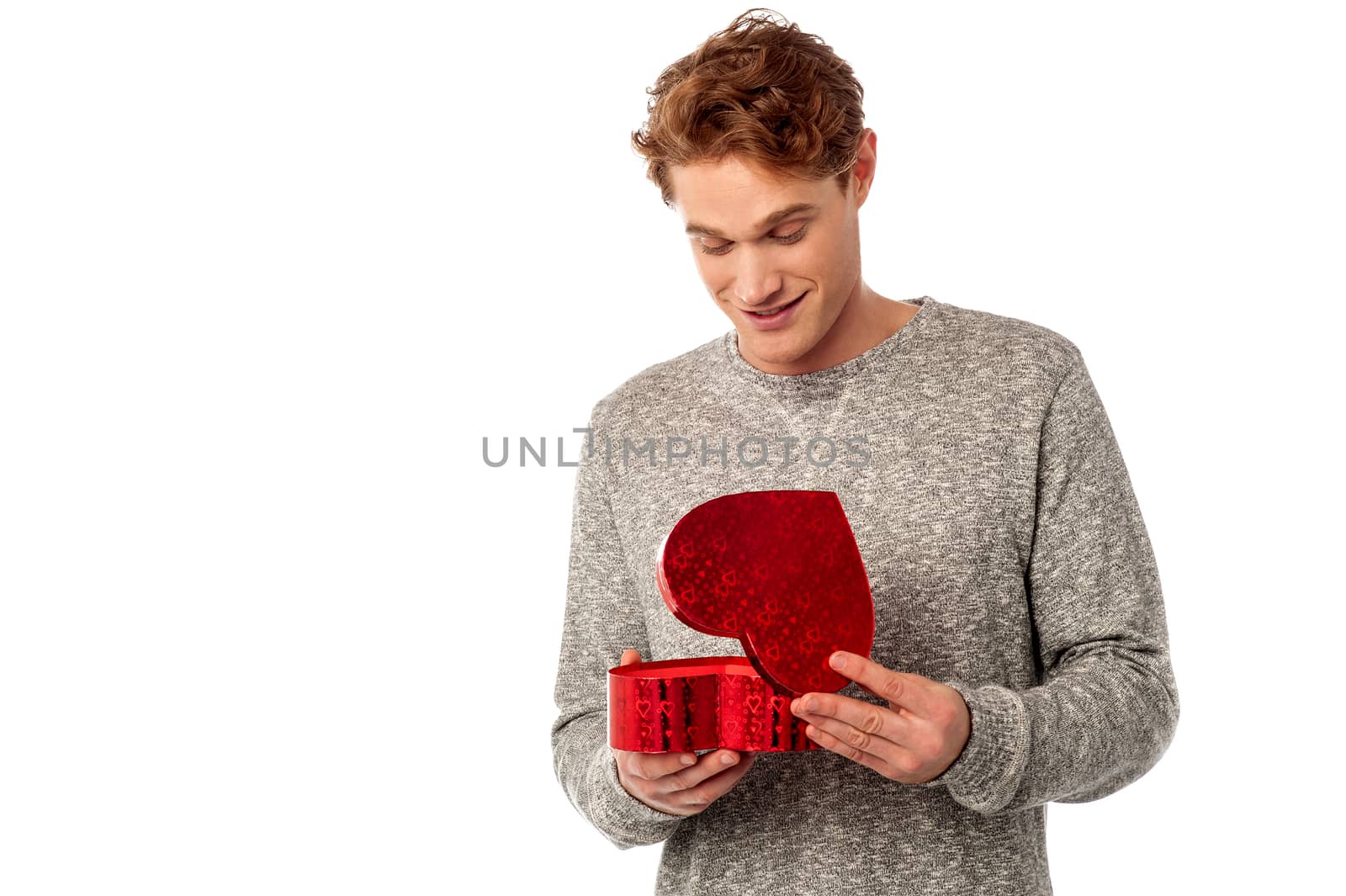 Casual young man opening his valentine gift