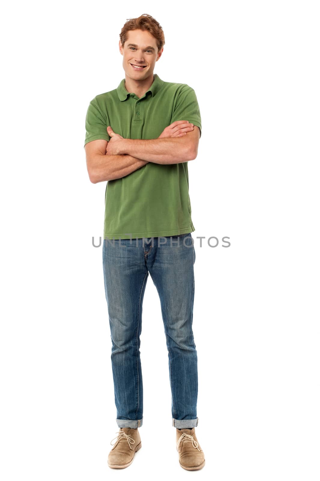 Full length of young man standing with crossed arms