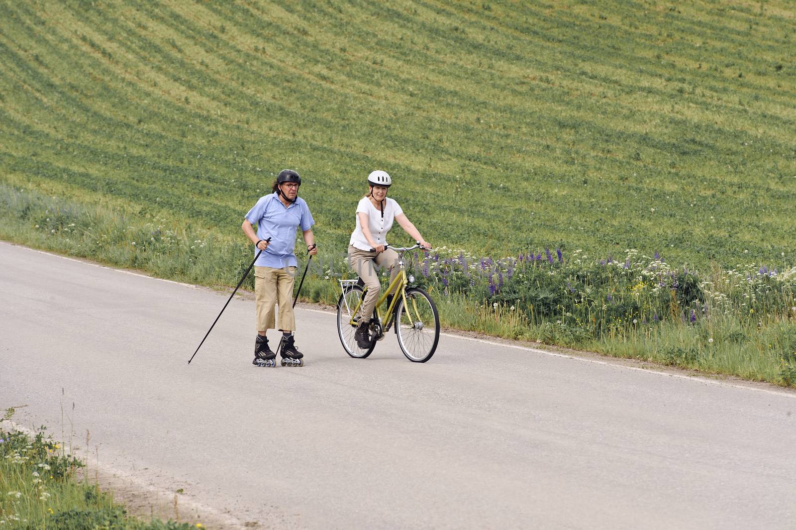 senior couple exercising outdoors by brendan_delany