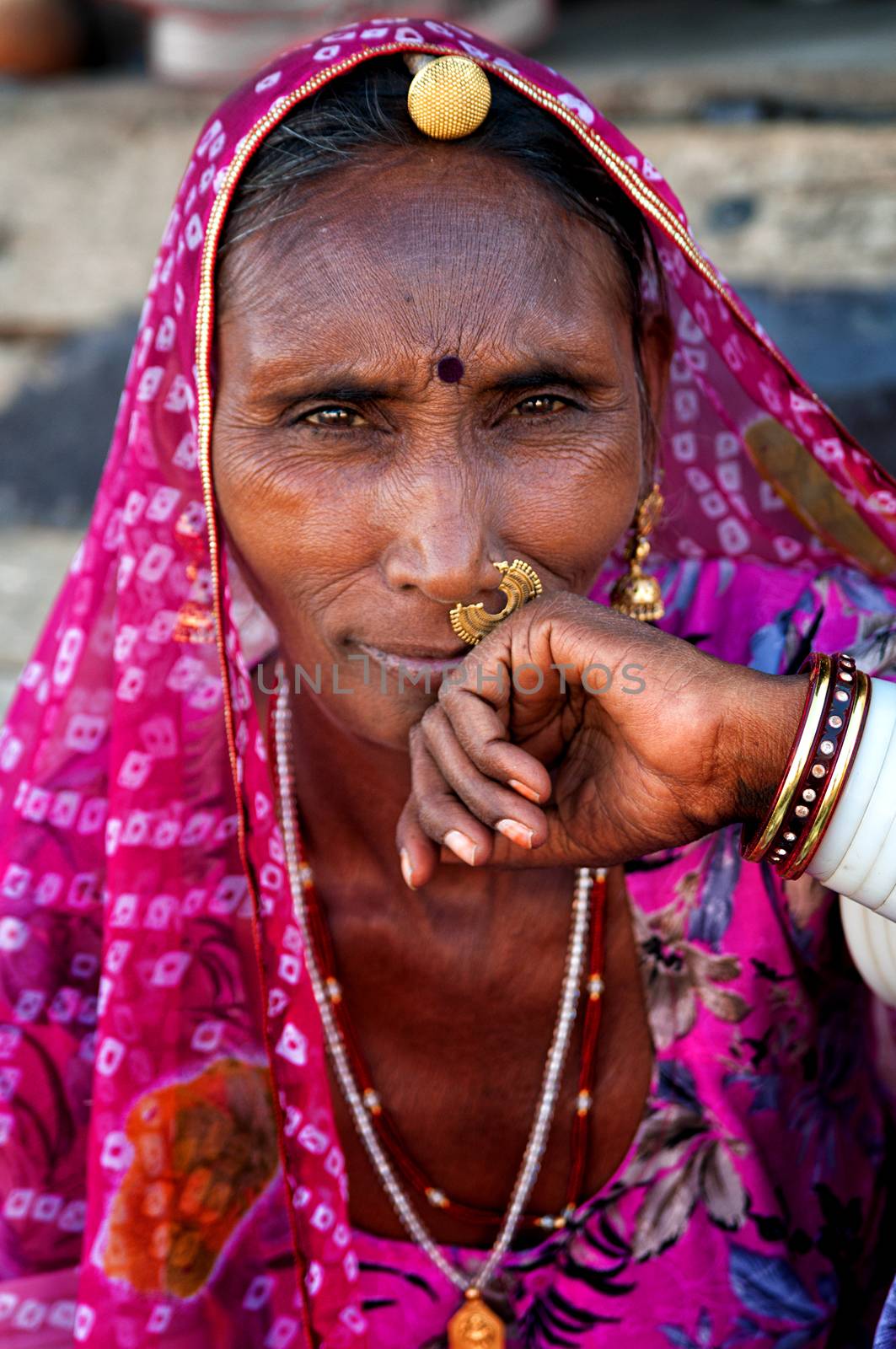 Indian woman in traditional colourful sari portrait Pushkar, India. March 3, 2013