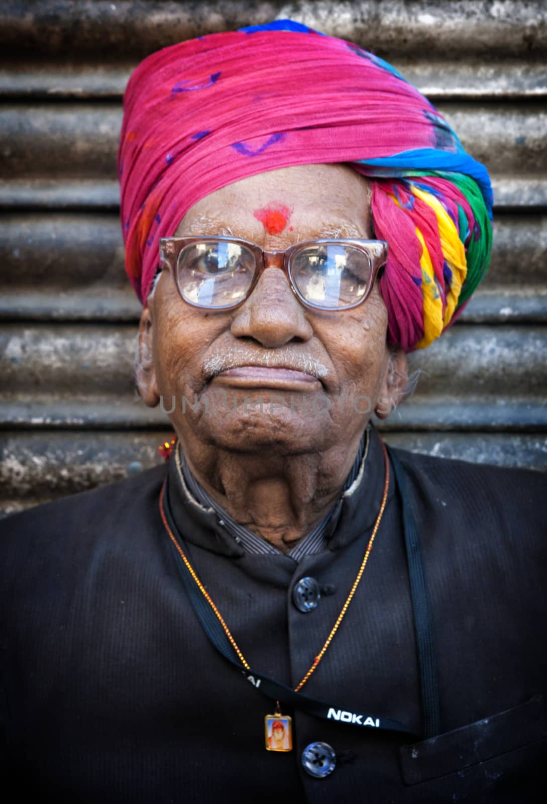 Indian man in colourful turban posing in Jodhpur, India. February 27, 2013