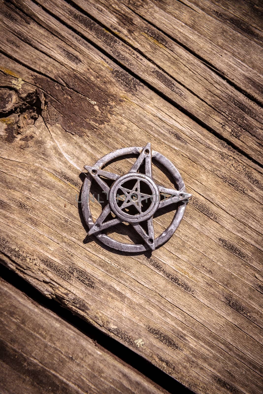 Old steel Pentagram closeup photo on background