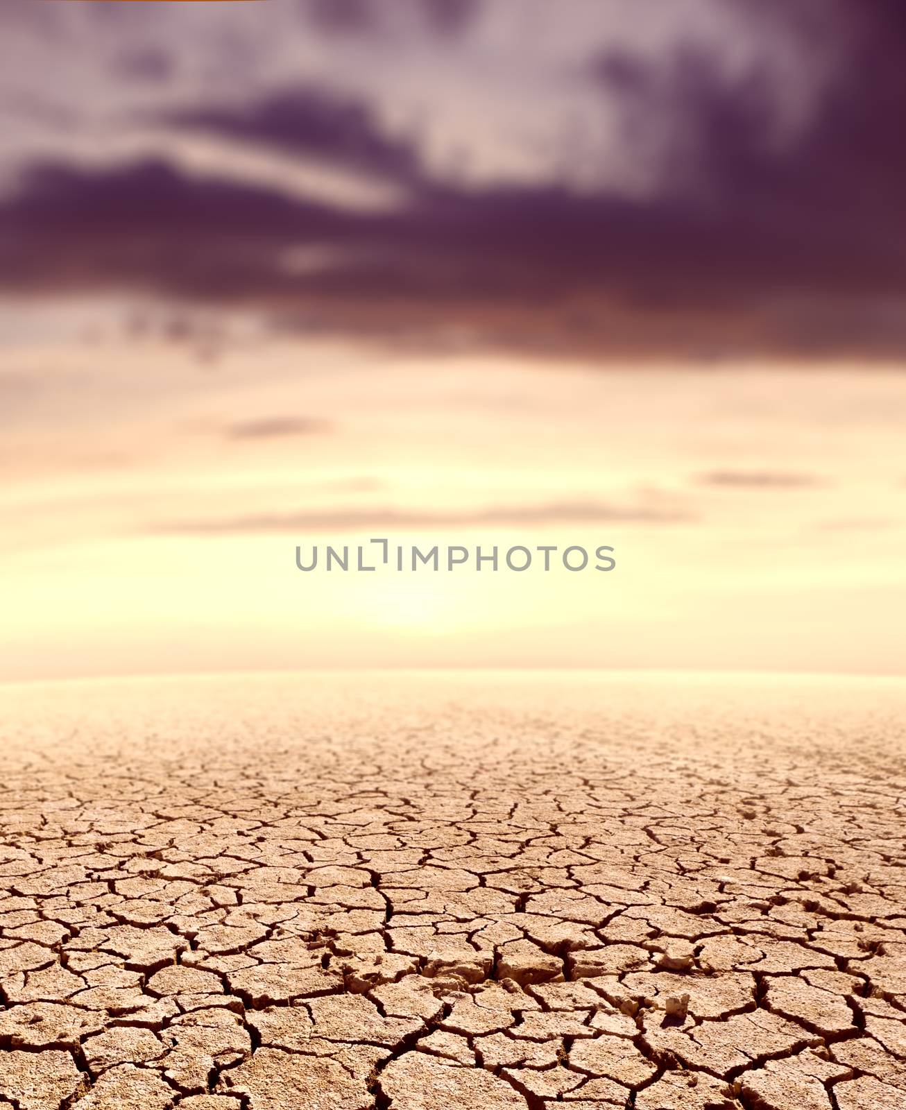 Desert landscape and sunset.Cracked soil by carloscastilla