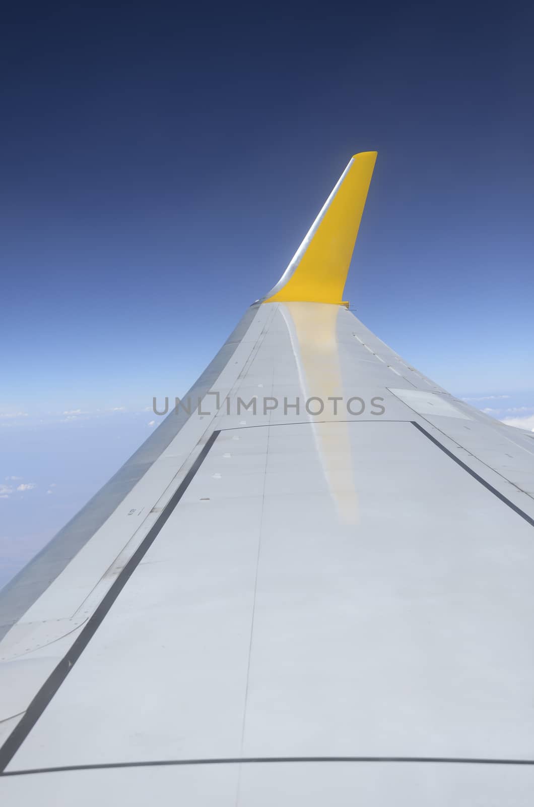 Wing of airplane flying in the sky