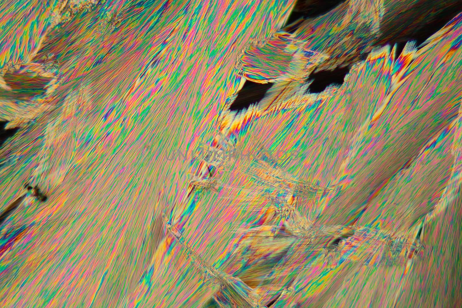 Crystals of acetylsalicylic acid under a microscope. The crystals are precipitated from a solution on a microscope slide and photographed in polarized light.