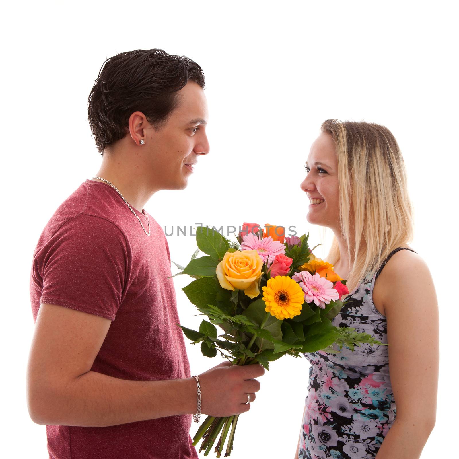 Boy is giving flowers to his girlfriend over white background