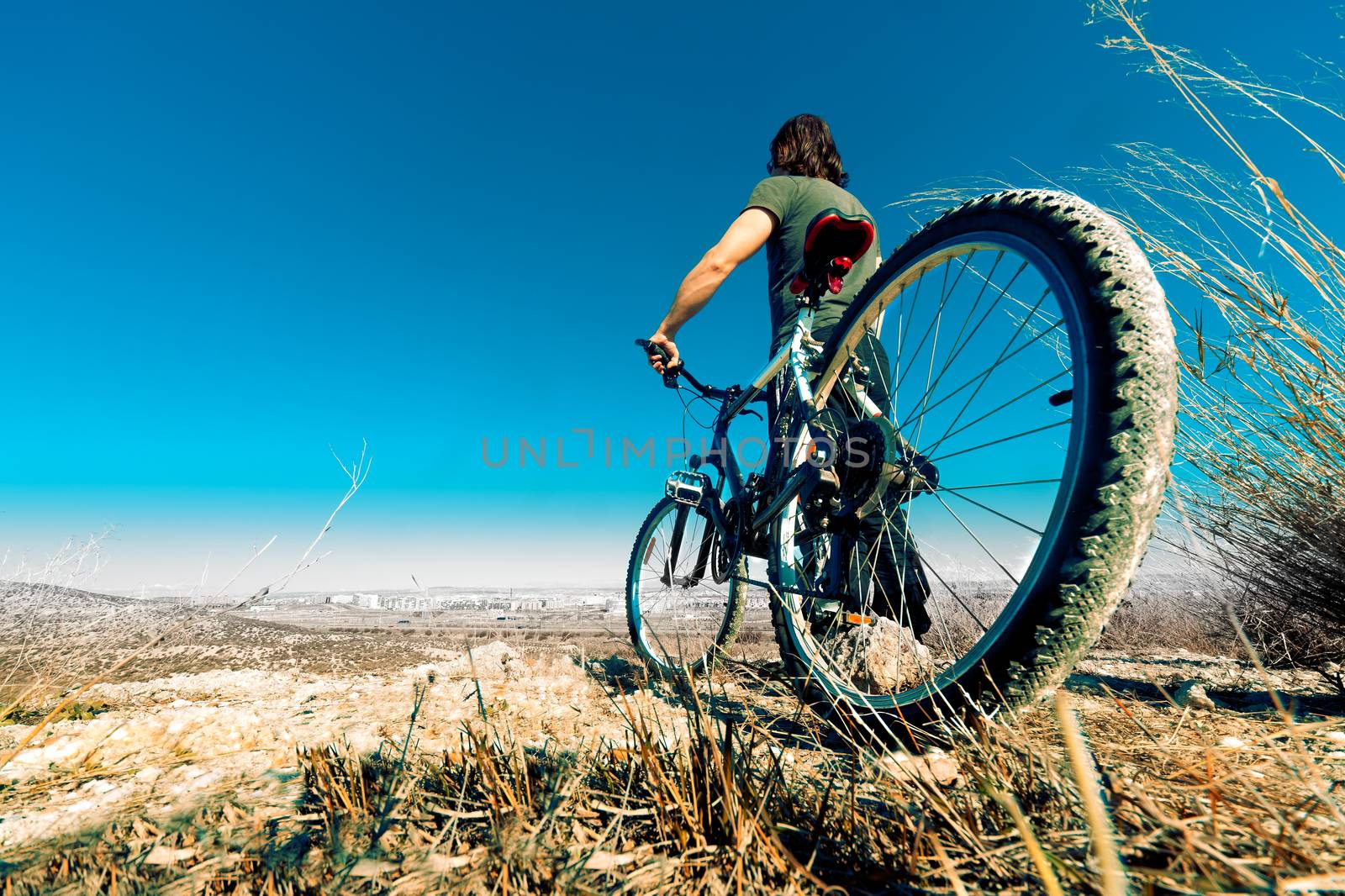 Mountain bike and young man by carloscastilla