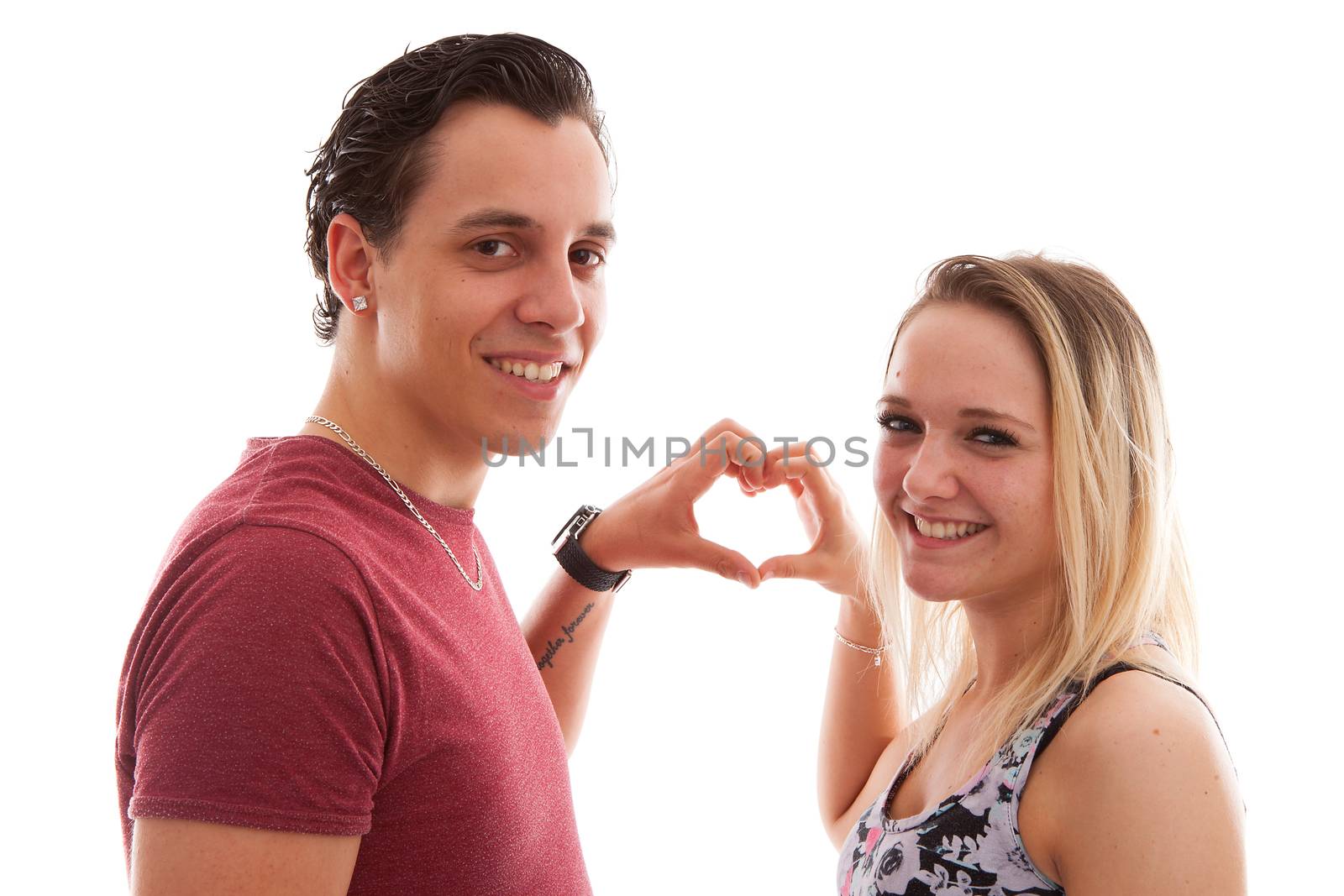 Young couple in lovemaking heart with hands over white background