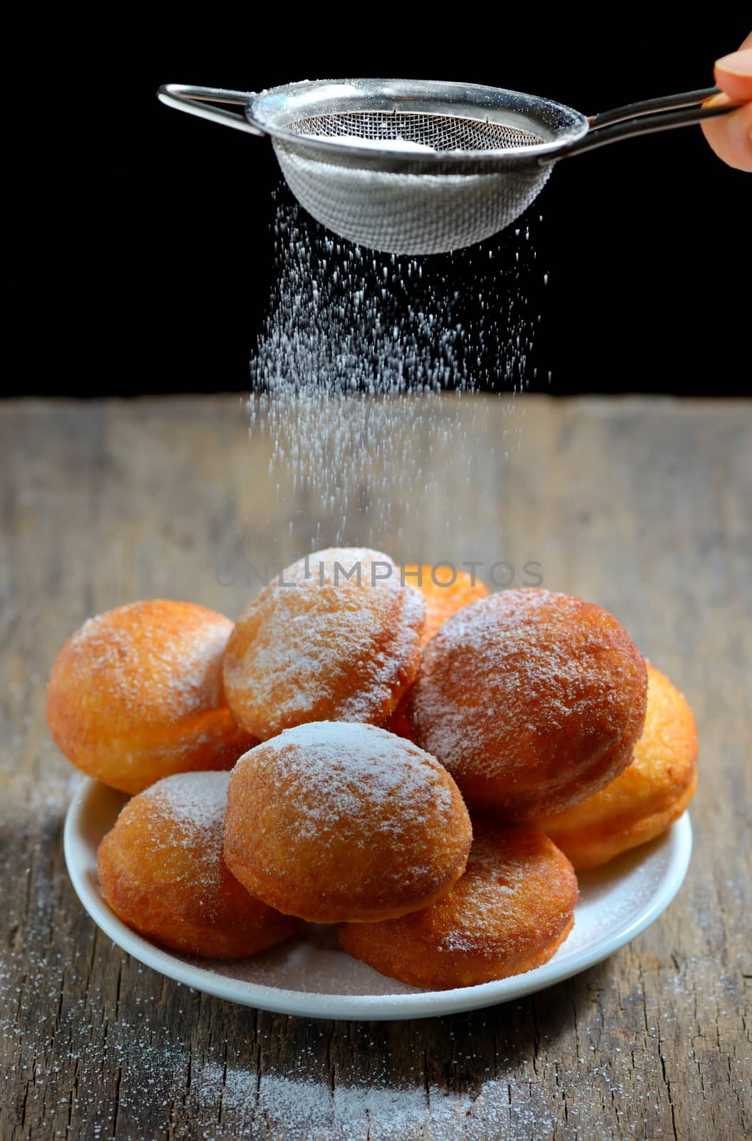 Donuts with powdered sugar on table