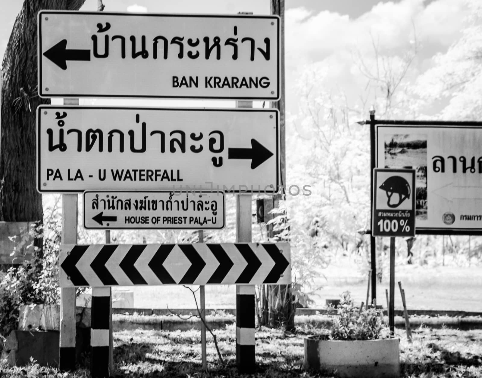 Black and White Infrared Road sign indicating distances to Ban Krarang, Pa La U Waterfall , Thailand