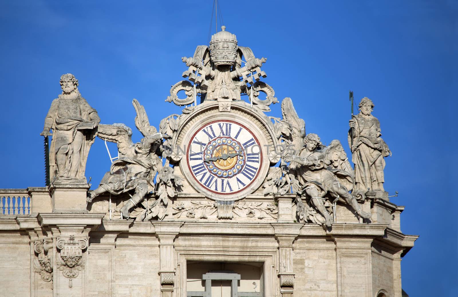 Maderno's facade with the clock between two statues, St. Peter's Basilica. Vatican City, Rome, Italy