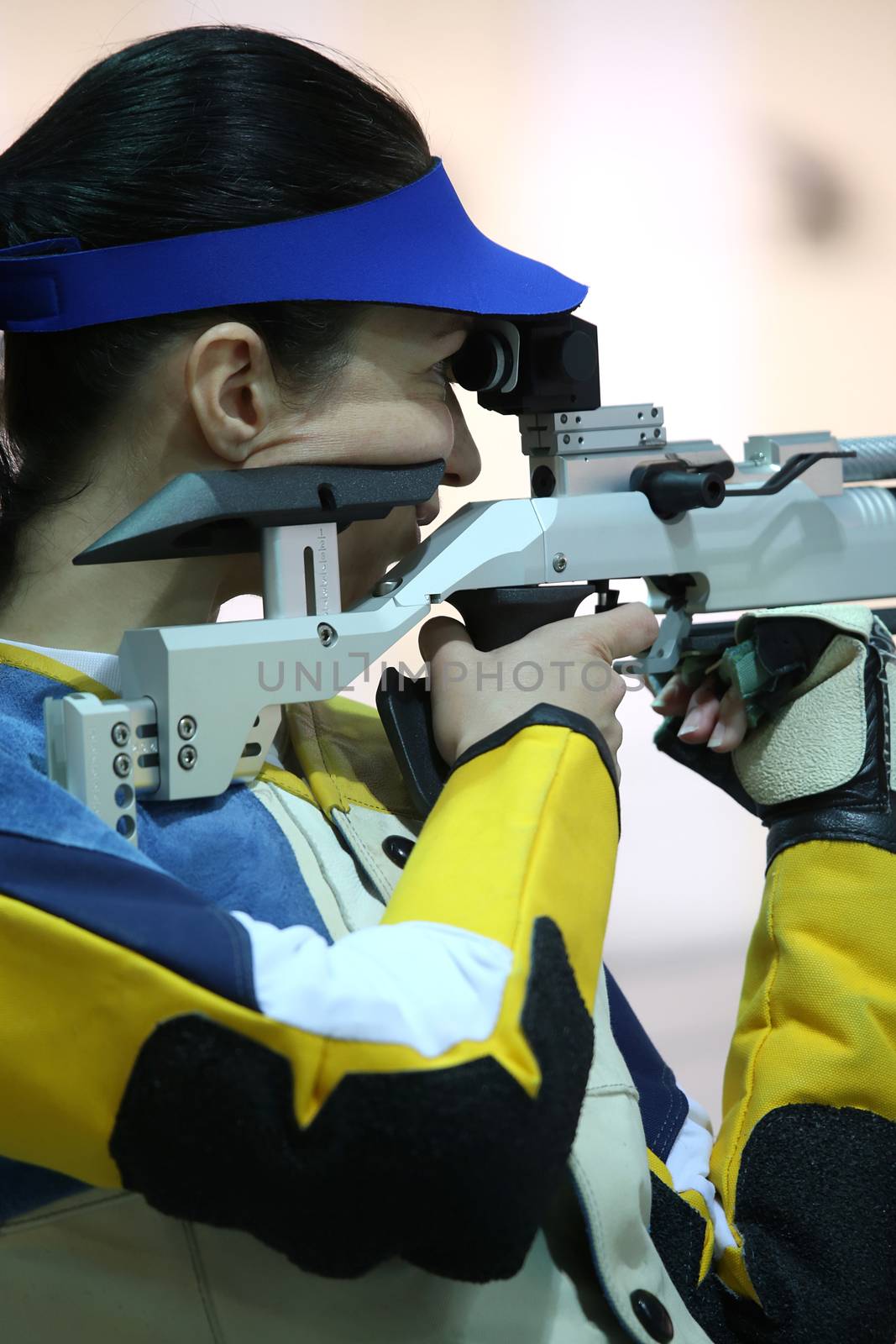 beautiful young woman aiming a pneumatic air rifle