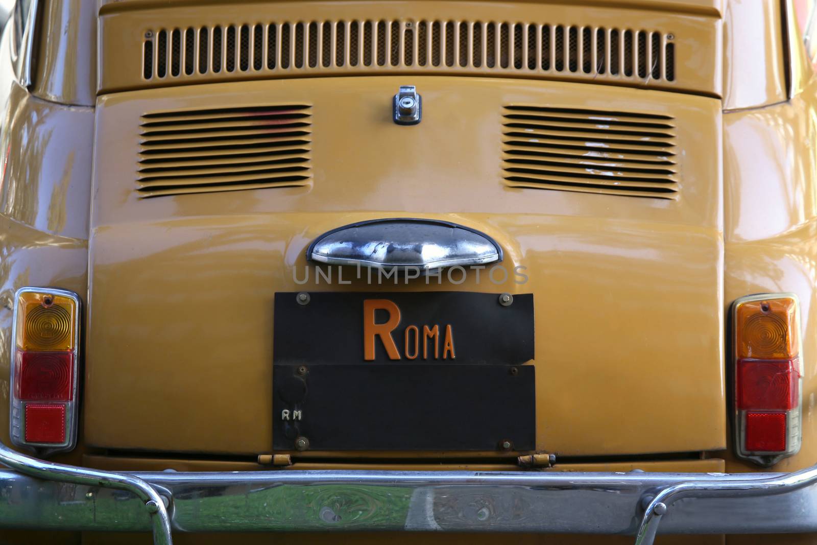 Old car at the city street parked in Rome, Italy