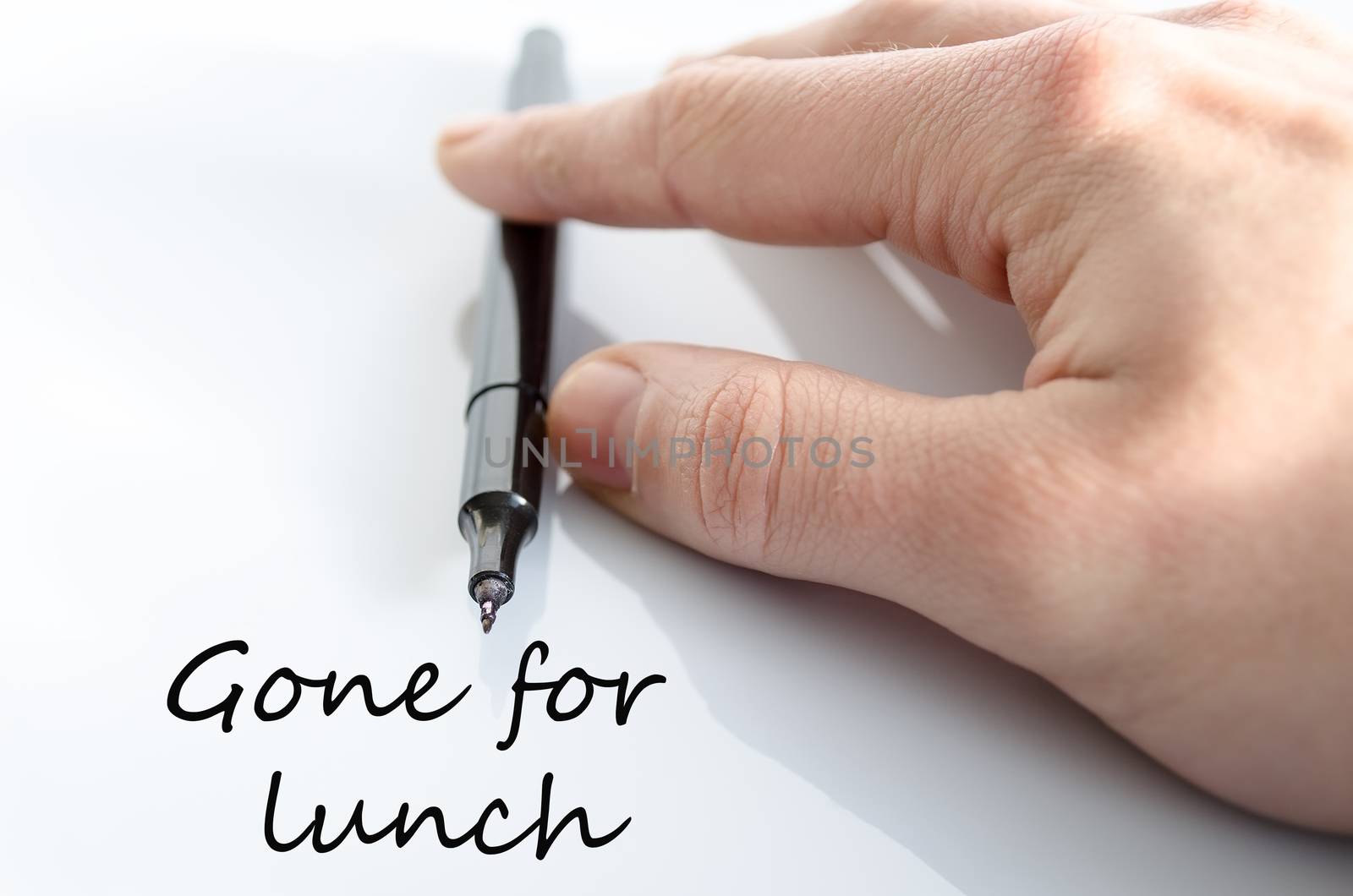 Pen in the hand isolated over white background Gone for lunch concept