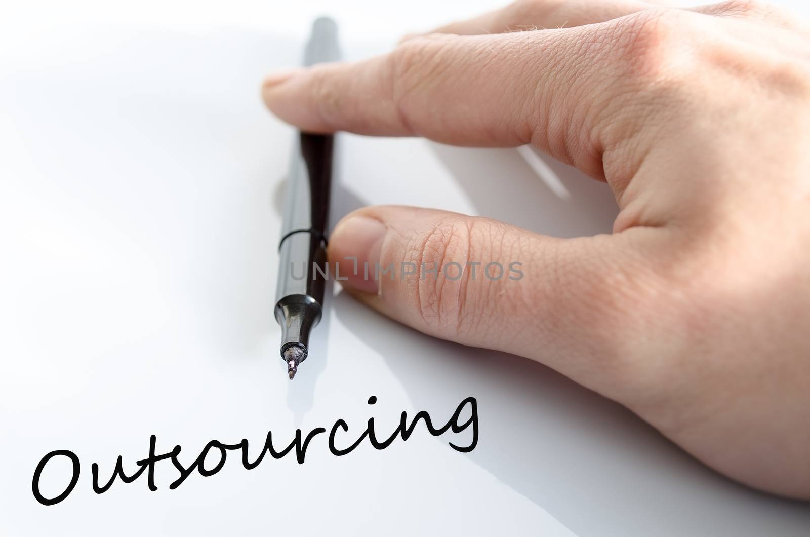 Pen in the hand isolated over white background Outsourcing Concept