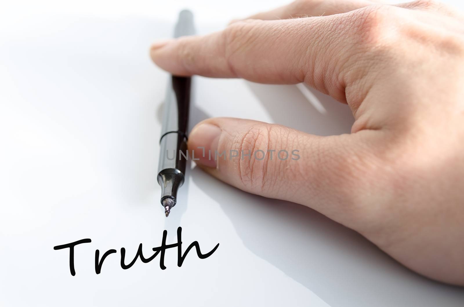 Pen in the hand isolated over white background Truth concept
