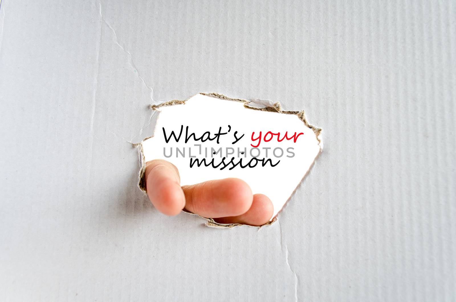 Hand and text on the cardboard background What's your mission concept
