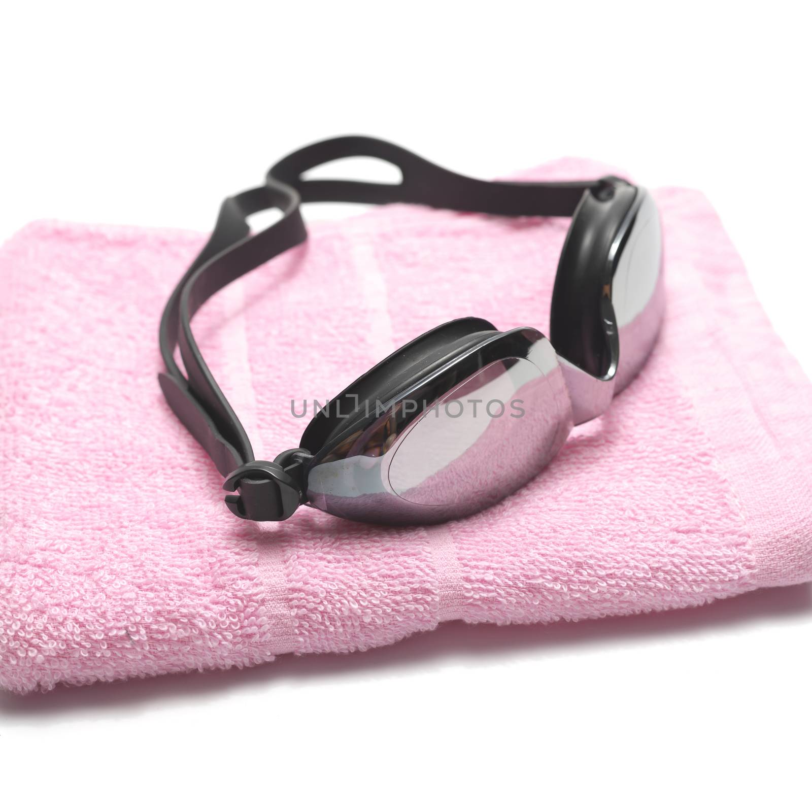 towel and swimming goggles isolated on white background