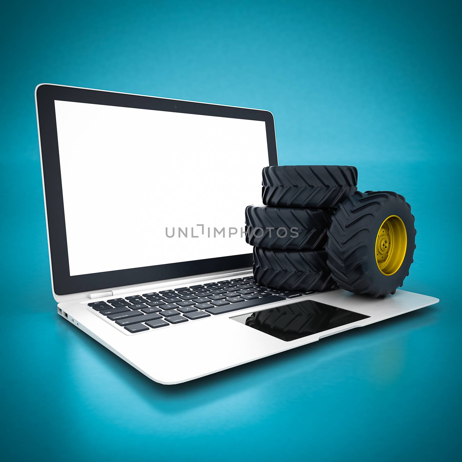 Tractor wheels and white laptop on a blue background