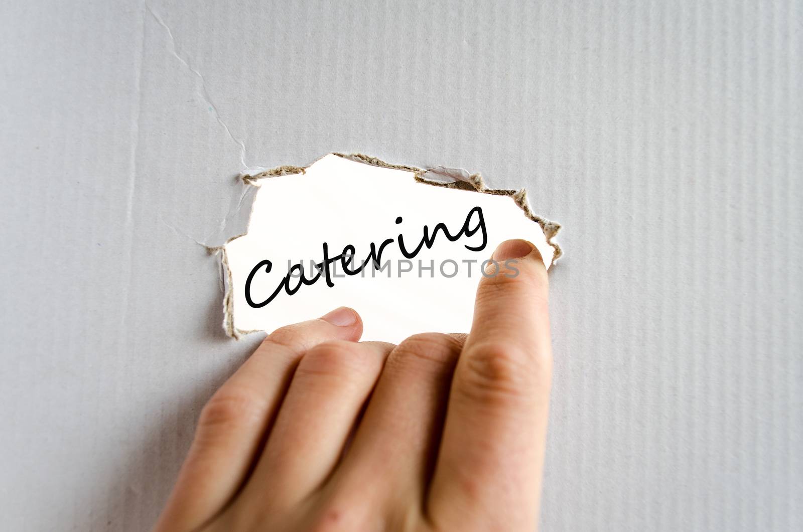 Hand and text on the cardboard background Catering