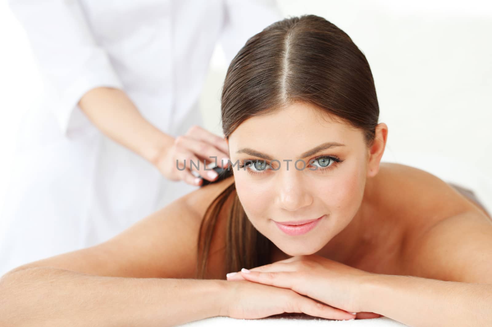 woman having stone therapy at spa session