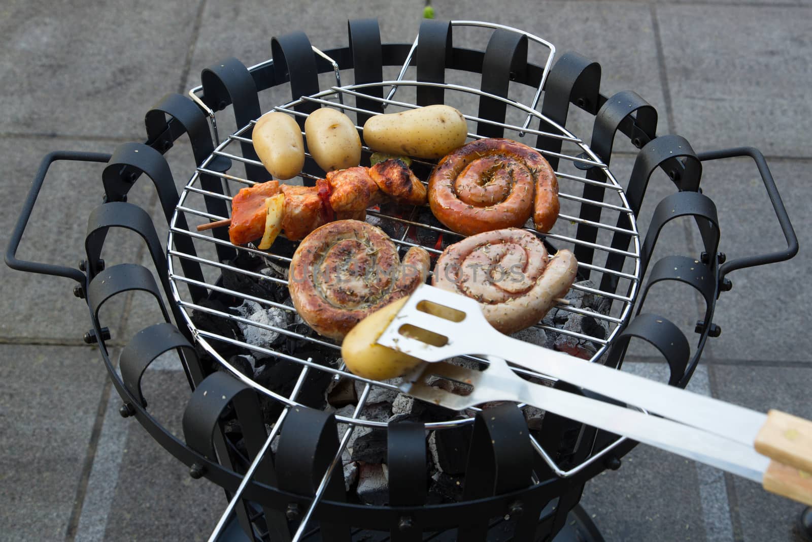 Cooking tasteful meat on a barbecue outside during winter