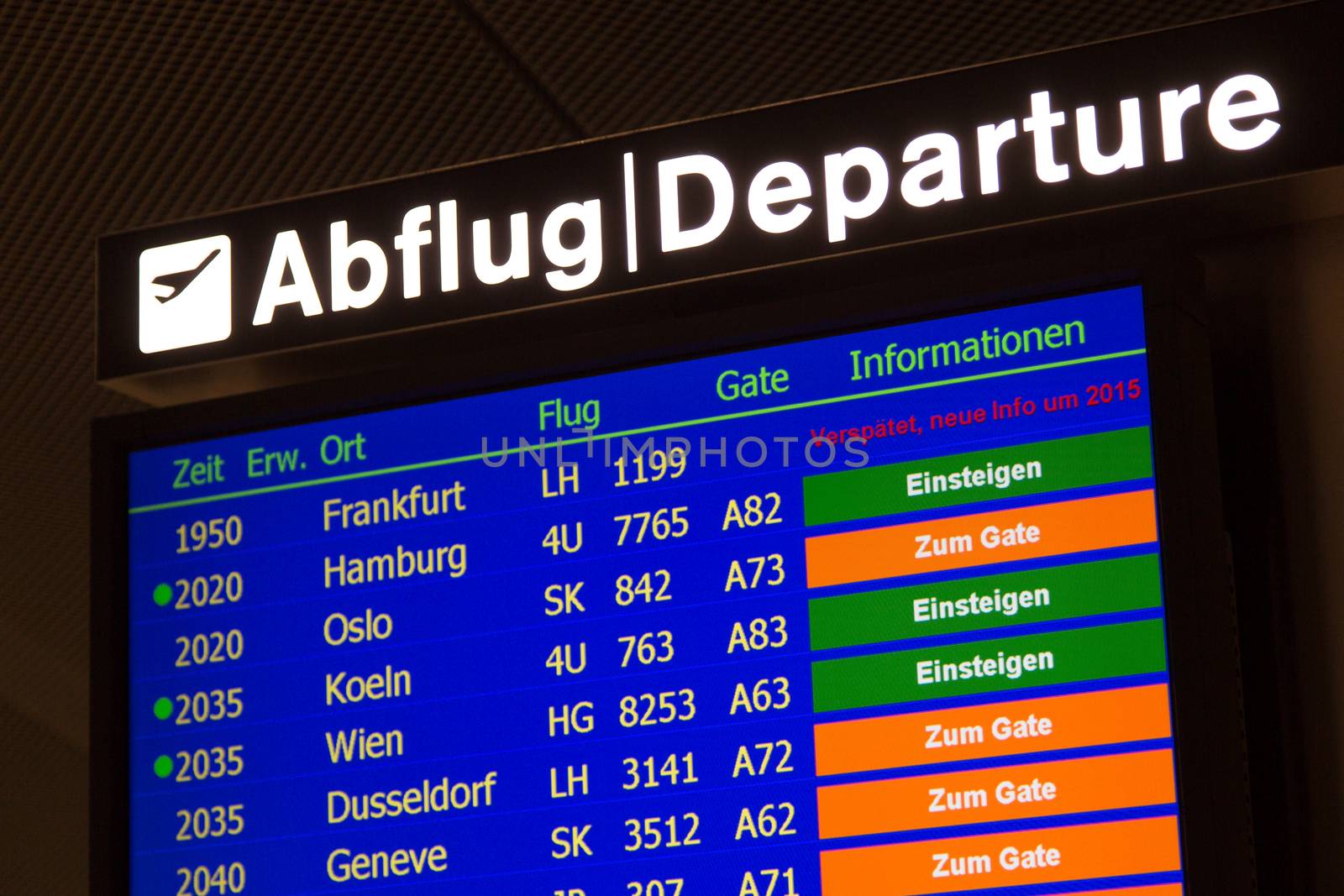 Airport departure board in terminal with flight information